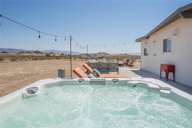 79124 Valle Vista Rd Unit 29, Palms, CA 92277 - view of swimming pool with a mountain view, a hot tub, and a patio area