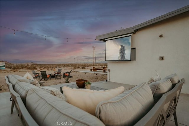 79124 Valle Vista Rd Unit 29, Palms, CA 92277 - patio terrace at dusk featuring an outdoor living space with a fire pit and a patio