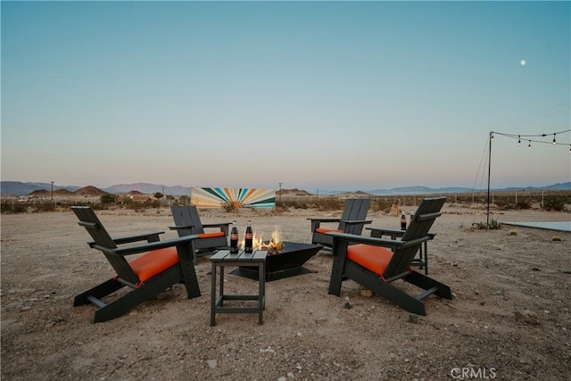 79124 Valle Vista Rd Unit 29, Palms, CA 92277 - yard at dusk with an outdoor fire pit and a mountain view