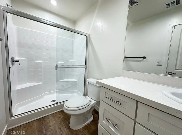 1340 Mariposa, Ridgecrest, CA 93555 - bathroom featuring wood finished floors, a shower stall, toilet, vanity, and recessed lighting