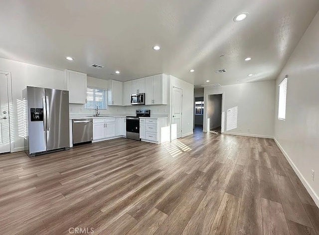 1340 Mariposa, Ridgecrest, CA 93555 - kitchen featuring appliances with stainless steel finishes, light countertops, plenty of natural light, white cabinetry, and recessed lighting