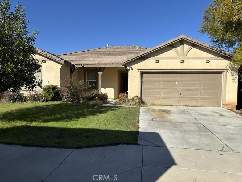 3080 Gazania Dr, Perris, CA 92571 - ranch-style house featuring an attached garage, stucco siding, concrete driveway, and a front yard