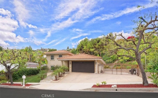 4784 Browndeer Ln, Rancho Palos Verdes, CA 90275 - mediterranean / spanish-style home featuring a tile roof, a garage, stucco siding, concrete driveway, and a gate