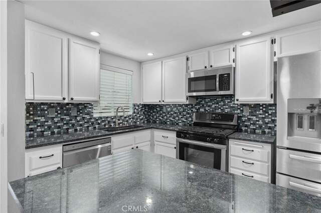23478 Cambridge Rd Unit 296, Yorba Linda, CA 92887 - kitchen with stainless steel appliances, a sink, white cabinets, dark stone countertops, and recessed lighting