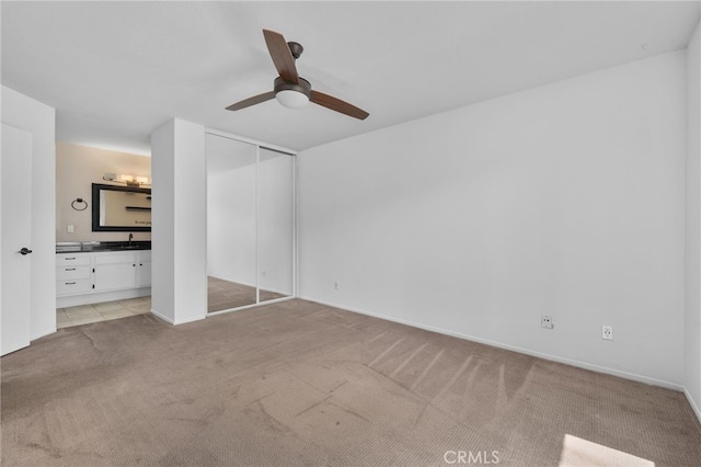 23478 Cambridge Rd Unit 296, Yorba Linda, CA 92887 - unfurnished bedroom with light carpet, ensuite bathroom, a closet, a sink, and ceiling fan