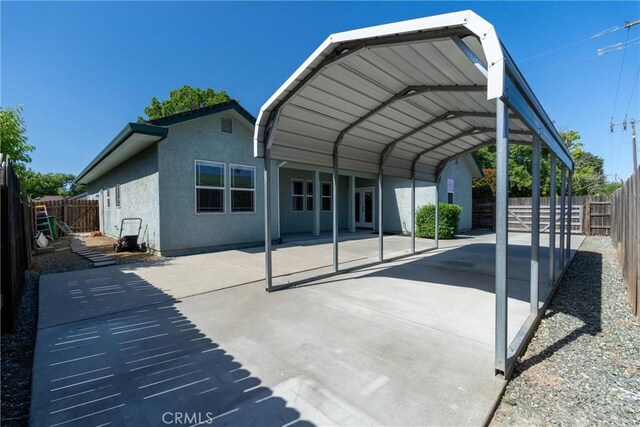 1095 Glenwood Ln, Willows, CA 95988 - back of property with a carport, stucco siding, and driveway