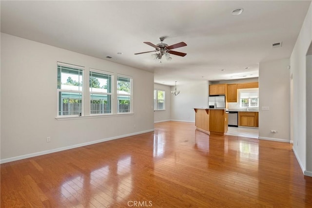 1095 Glenwood Ln, Willows, CA 95988 - unfurnished living room featuring baseboards, light wood-type flooring, and ceiling fan