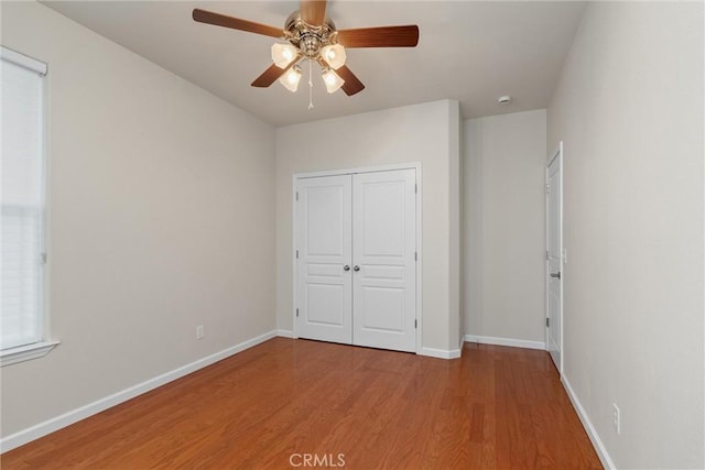 1095 Glenwood Ln, Willows, CA 95988 - unfurnished bedroom featuring wood finished floors, baseboards, a ceiling fan, and a closet