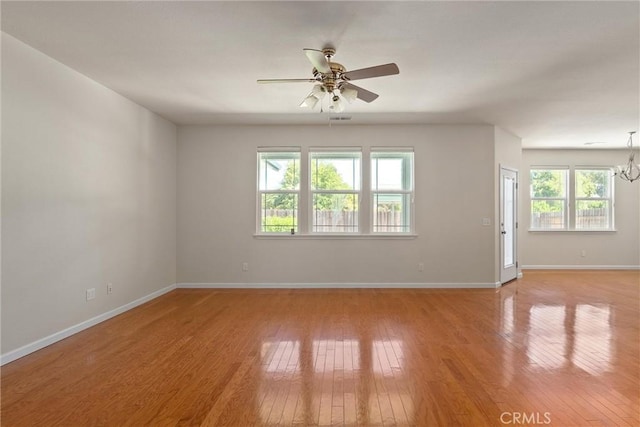 1095 Glenwood Ln, Willows, CA 95988 - spare room featuring ceiling fan, baseboards, light wood-style flooring, and a chandelier