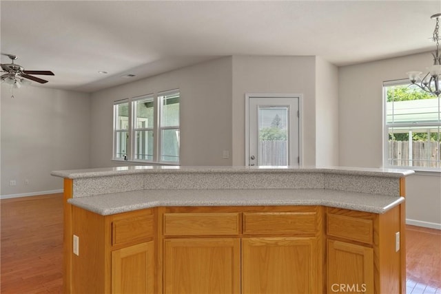 1095 Glenwood Ln, Willows, CA 95988 - kitchen with light wood finished floors, baseboards, ceiling fan, and light countertops
