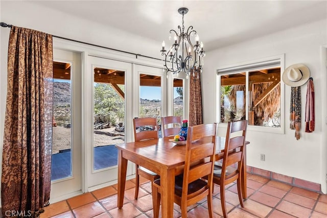 8830 Quail Springs Rd, Joshua Tree, CA 92252 - dining room with healthy amount of natural light, light tile patterned flooring, and a chandelier