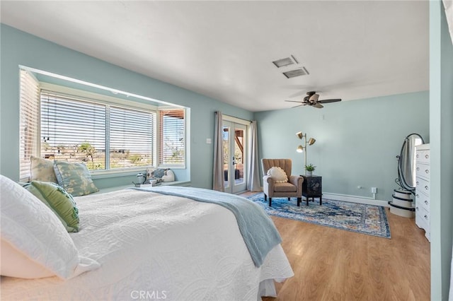 8830 Quail Springs Rd, Joshua Tree, CA 92252 - bedroom featuring light wood-type flooring, baseboards, access to outside, ceiling fan, and french doors