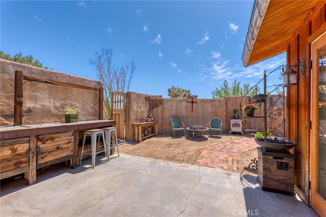 8830 Quail Springs Rd, Joshua Tree, CA 92252 - fenced backyard with a patio area and a fire pit