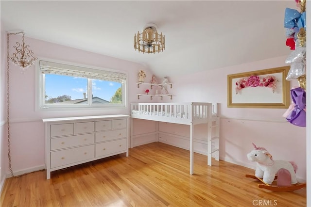 5492 Carousel Cir, Garden Grove, CA 92845 - bedroom featuring light wood finished floors, vaulted ceiling, a chandelier, and baseboards