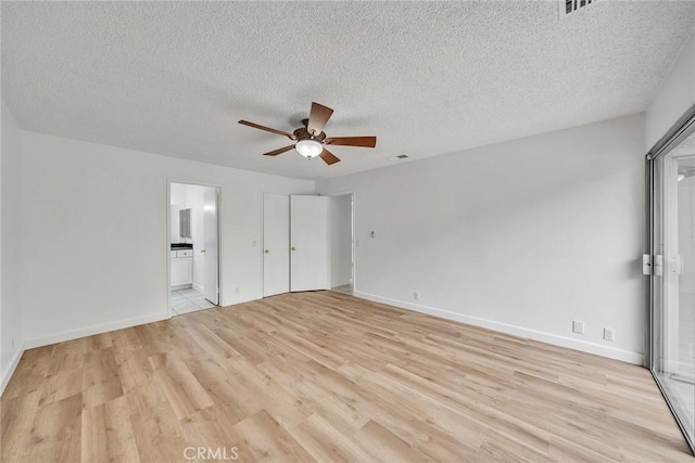 901 Golden Springs Dr Unit D13, Diamond Bar, CA 91765 - unfurnished bedroom featuring light wood finished floors, a textured ceiling, baseboards, ensuite bath, and ceiling fan