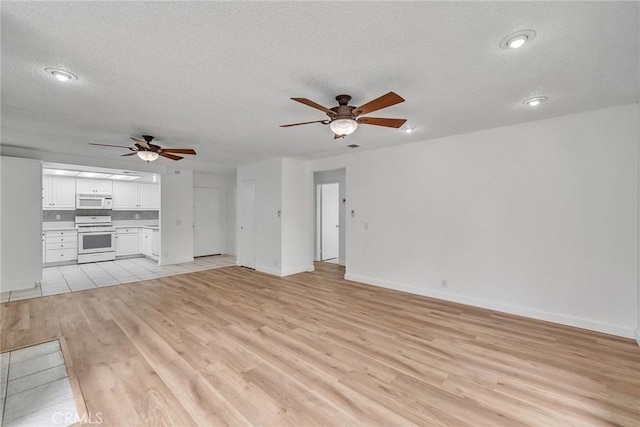 901 Golden Springs Dr Unit D13, Diamond Bar, CA 91765 - unfurnished living room with a ceiling fan, a textured ceiling, light wood finished floors, baseboards, and recessed lighting