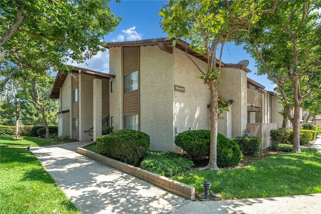 901 Golden Springs Dr Unit D13, Diamond Bar, CA 91765 - view of home's exterior featuring stucco siding and a yard