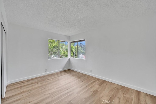 901 Golden Springs Dr Unit D13, Diamond Bar, CA 91765 - spare room featuring light wood finished floors, a textured ceiling, and baseboards