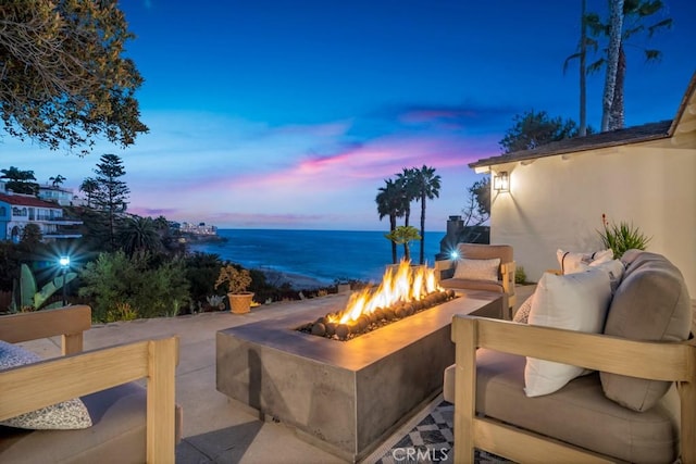 10 Camel Pt, Laguna Beach, CA 92651 - view of patio / terrace with an outdoor living space with a fire pit and a water view