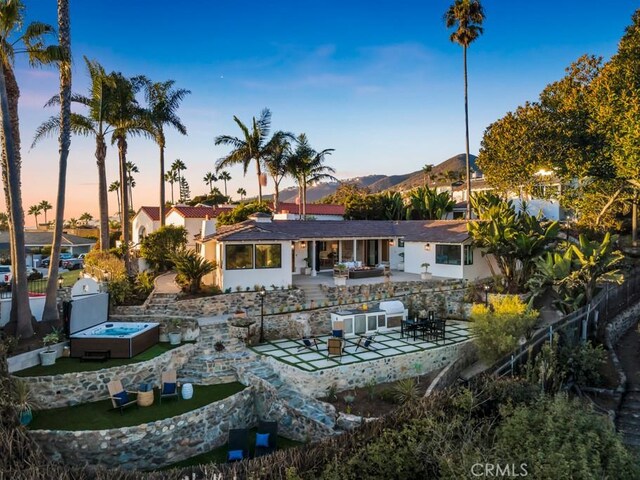 10 Camel Pt, Laguna Beach, CA 92651 - back of house with a patio area, an outdoor hot tub, and stucco siding