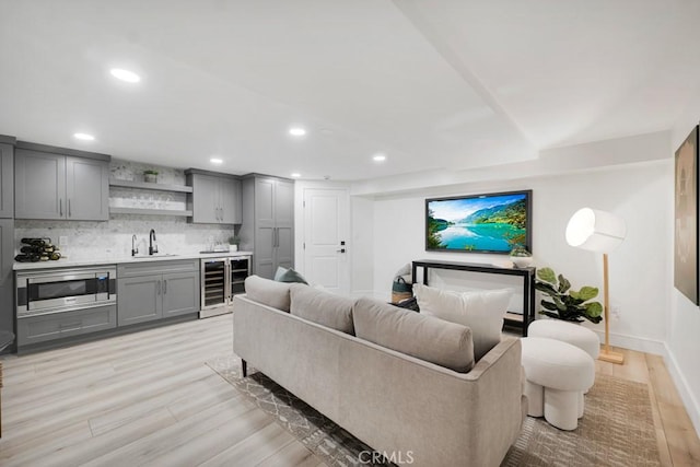 10 Camel Pt, Laguna Beach, CA 92651 - living room featuring wine cooler, wet bar, light wood-type flooring, recessed lighting, and baseboards