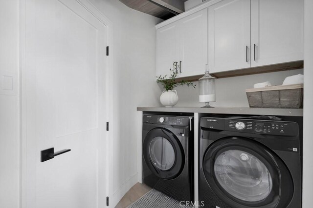 10 Camel Pt, Laguna Beach, CA 92651 - laundry room with washing machine and dryer, cabinet space, and light wood-style floors