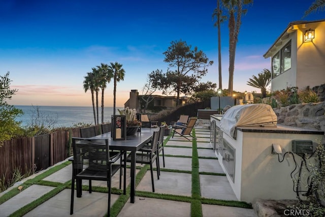 10 Camel Pt, Laguna Beach, CA 92651 - fenced backyard with a patio area, outdoor dining space, and a water view