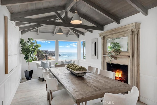 10 Camel Pt, Laguna Beach, CA 92651 - dining area with light wood-type flooring, a premium fireplace, a water view, wooden ceiling, and wainscoting