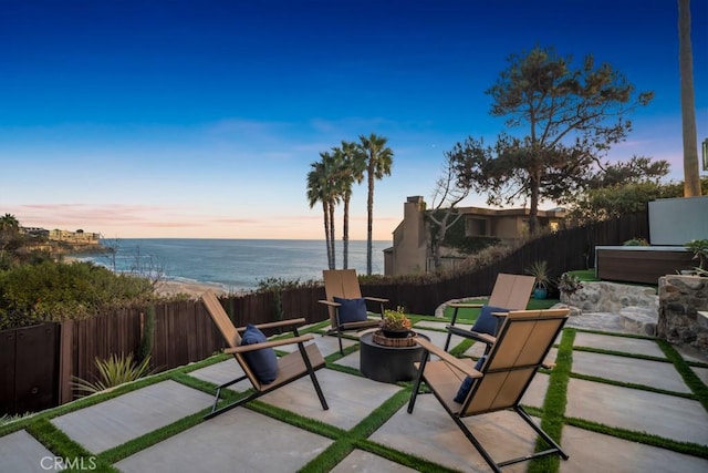 10 Camel Pt, Laguna Beach, CA 92651 - fenced backyard featuring a patio area, a water view, and a fire pit