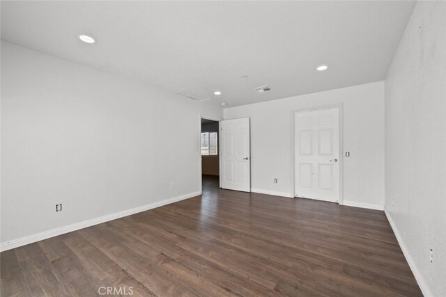 8225 W W Ave E4, Lancaster, CA 93536 - unfurnished bedroom with wood finished floors, baseboards, and recessed lighting
