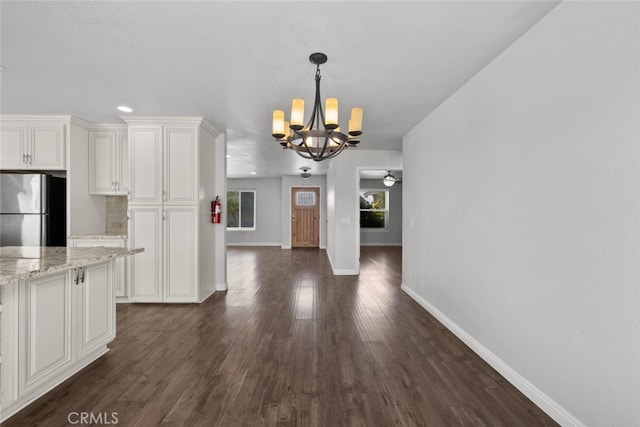 8225 W W Ave E4, Lancaster, CA 93536 - kitchen with freestanding refrigerator, a chandelier, baseboards, dark wood-type flooring, and recessed lighting