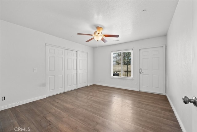 8225 W W Ave E4, Lancaster, CA 93536 - unfurnished bedroom featuring wood finished floors, baseboards, and a closet