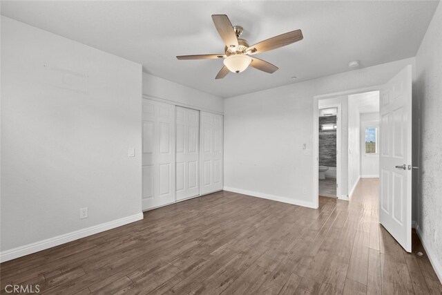 8225 W W Ave E4, Lancaster, CA 93536 - unfurnished bedroom featuring dark wood-type flooring, baseboards, a closet, and ceiling fan