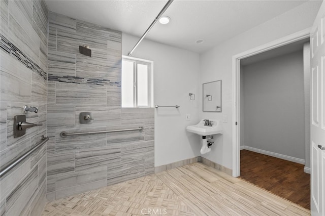 8225 W W Ave E4, Lancaster, CA 93536 - bathroom featuring a tile shower, baseboards, and recessed lighting