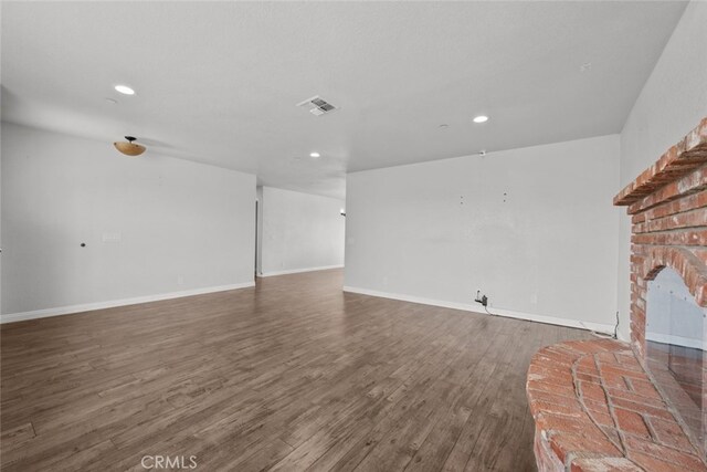 8225 W W Ave E4, Lancaster, CA 93536 - unfurnished living room with wood finished floors, recessed lighting, a fireplace, and baseboards