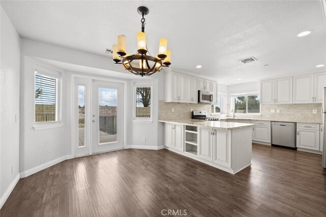 8225 W W Ave E4, Lancaster, CA 93536 - kitchen featuring stainless steel appliances, a chandelier, decorative backsplash, dark wood-type flooring, and recessed lighting