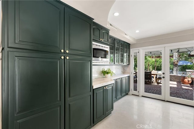 1761 Lemon Ter, North Tustin, CA 92705 - kitchen with green cabinetry, stainless steel microwave, french doors, recessed lighting, and glass insert cabinets