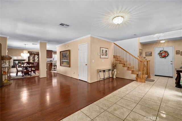 16290 Via Ultimo, Moreno Valley, CA 92551 - foyer entrance with stairs, ornamental molding, light tile patterned floors, and baseboards