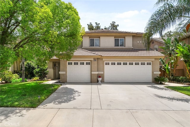 16290 Via Ultimo, Moreno Valley, CA 92551 - view of front facade featuring stucco siding, a garage, driveway, a tiled roof, and a front lawn