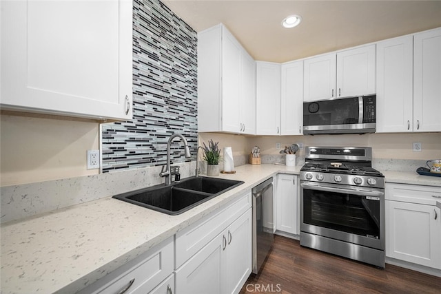 4435 Via Del Prado, Yorba Linda, CA 92886 - kitchen with appliances with stainless steel finishes, white cabinetry, backsplash, light stone countertops, and recessed lighting
