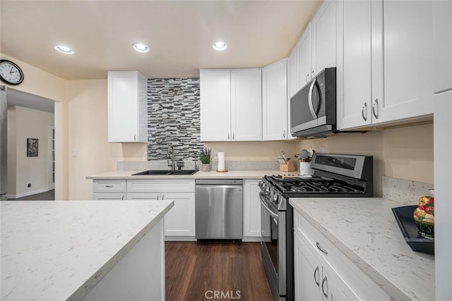 4435 Via Del Prado, Yorba Linda, CA 92886 - kitchen with appliances with stainless steel finishes, white cabinetry, light stone countertops, dark wood-type flooring, and recessed lighting