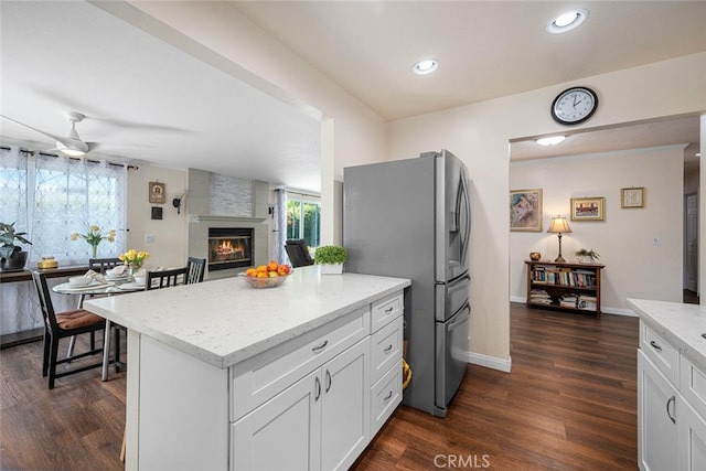 4435 Via Del Prado, Yorba Linda, CA 92886 - kitchen with stainless steel fridge with ice dispenser, ceiling fan, dark wood finished floors, light stone counters, and white cabinetry