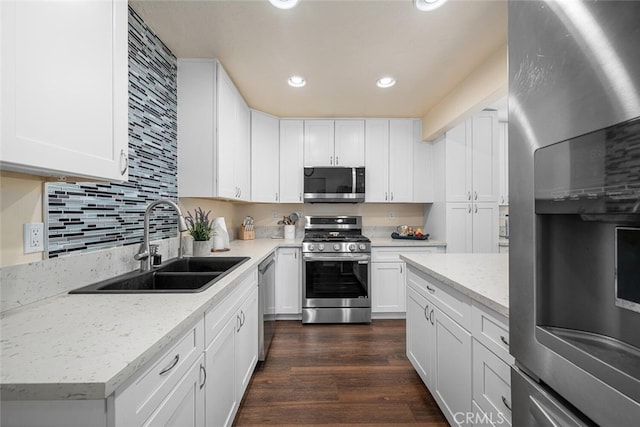 4435 Via Del Prado, Yorba Linda, CA 92886 - kitchen with appliances with stainless steel finishes, recessed lighting, white cabinets, dark wood-type flooring, and light stone counters