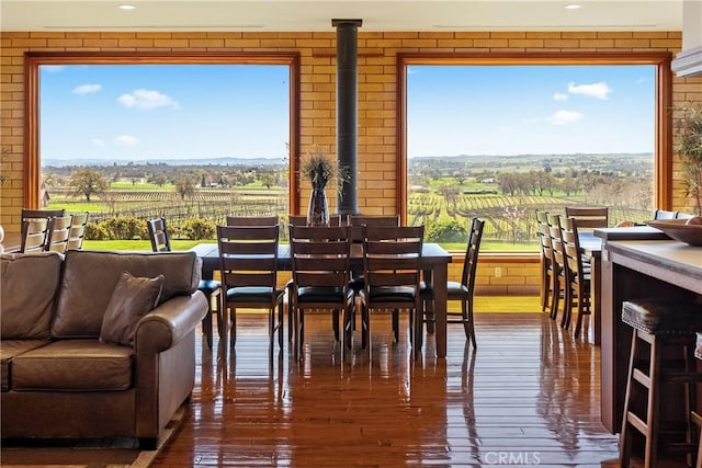 5010 Gate 4 Rd, Paso Robles, CA 93446 - dining space with a rural view, hardwood / wood-style flooring, healthy amount of natural light, agricultural plots, and brick wall
