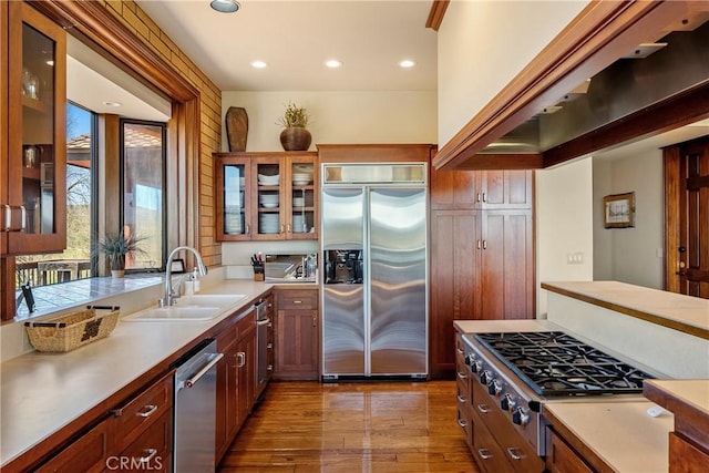 5010 Gate 4 Rd, Paso Robles, CA 93446 - kitchen with stainless steel appliances, a sink, wood finished floors, recessed lighting, and glass insert cabinets