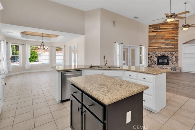 6786 Middleton Ave, Hesperia, CA 92345 - kitchen with open floor plan, dishwasher, a kitchen island, ceiling fan, and light tile patterned floors