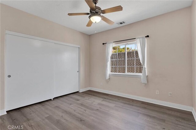 6786 Middleton Ave, Hesperia, CA 92345 - unfurnished bedroom featuring wood finished floors, a closet, and a ceiling fan