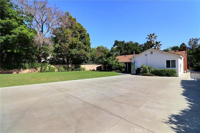 2953 E California Blvd, Pasadena, CA 91107 - view of front facade featuring a front yard, driveway, stucco siding, and a chimney