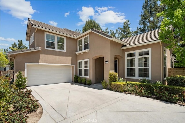 26974 Colonial Ln, Valencia, CA 91355 - view of front of home with concrete driveway, a garage, a tiled roof, and stucco siding