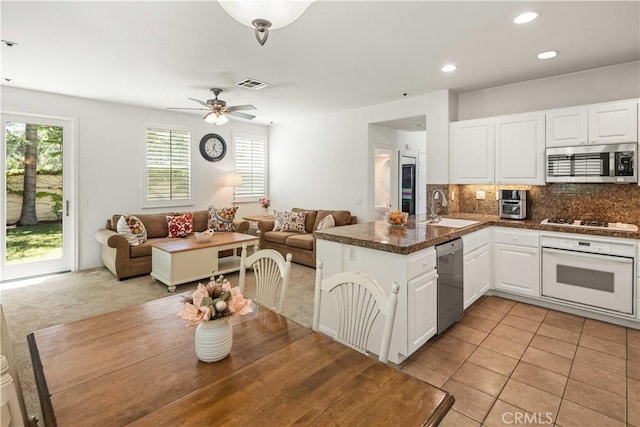 26974 Colonial Ln, Valencia, CA 91355 - kitchen featuring stainless steel appliances, a sink, a peninsula, dark countertops, and open floor plan